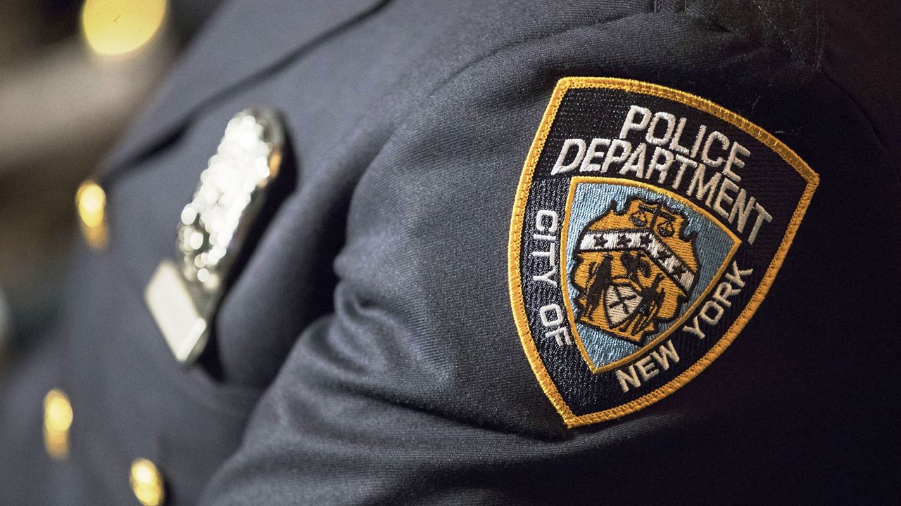 NYPD badge on a black uniform.
