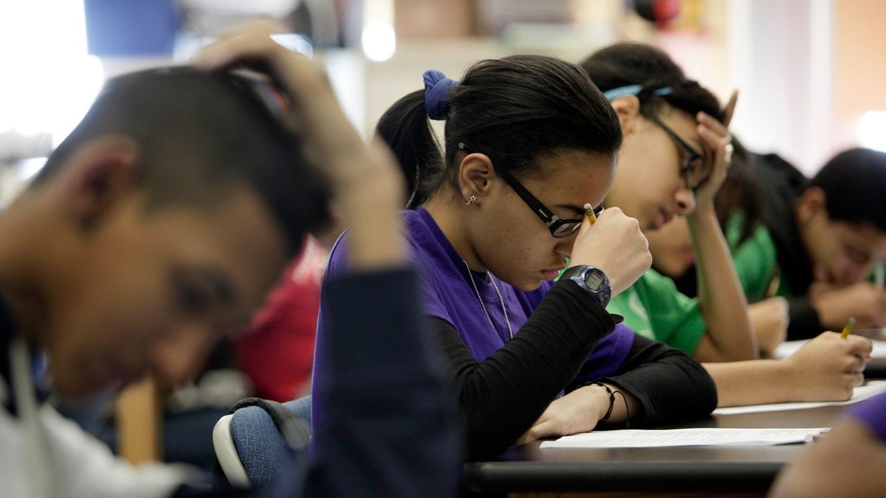 In a March 3, 2011 photo, students take a test during a Global History class at the Washington Heights Expeditionary Learning School, in New York.  As Mayor Michael Bloomberg plans to take more than 6,000 teachers off the payroll to help balance a strained budget, some parent advocates are questioning what the layoffs will do to New York public school class sizes. 