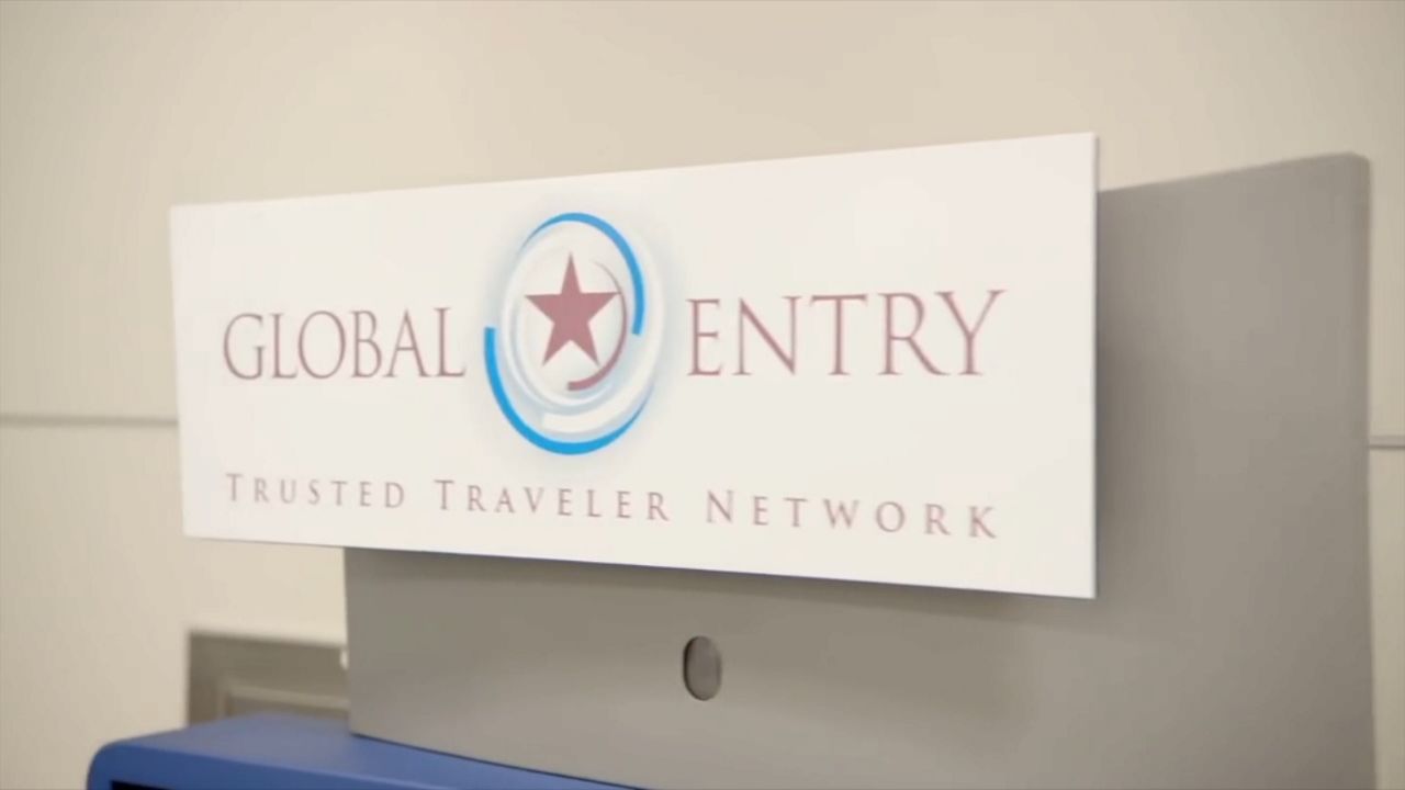 A white sign with text for the Global Entry program logo and text.