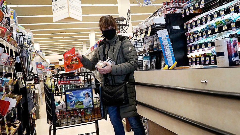 A person wears a facial mask in a retail store in this file image. (Associated Press)
