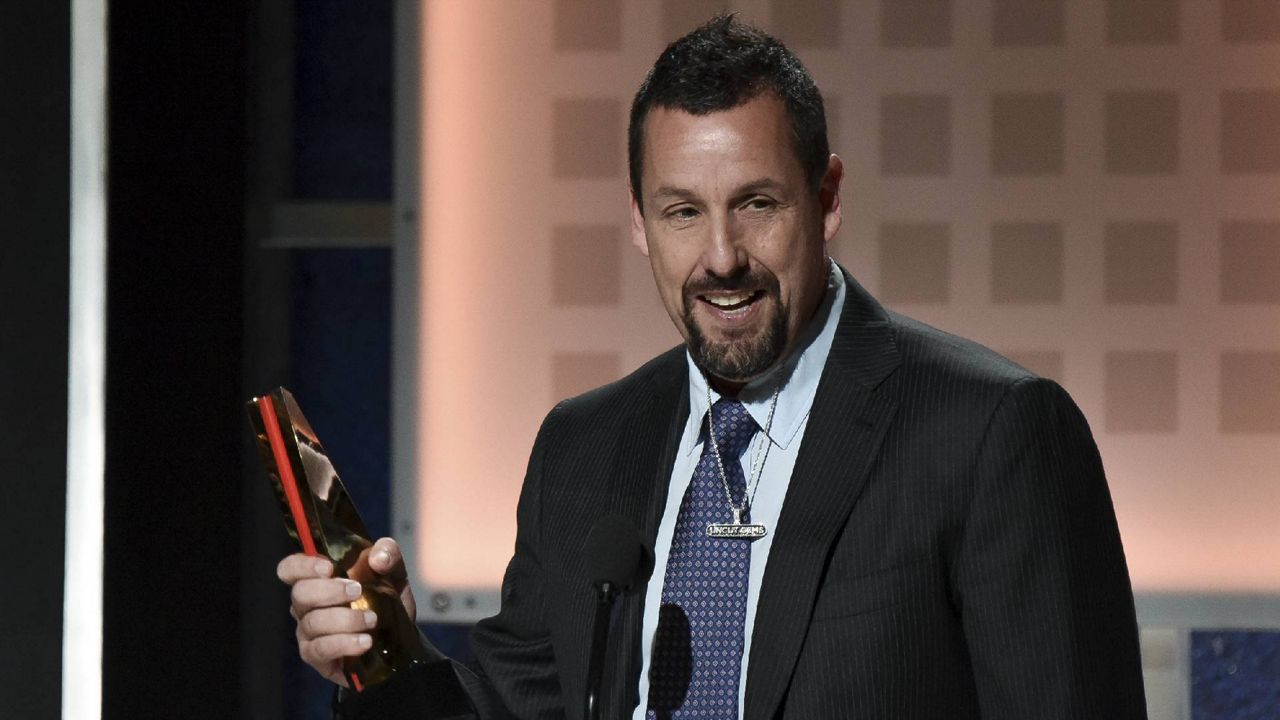 Adam Sandler accepts the award for Best Actor at the 19th Annual Movies For Grownups Awards at the Beverly Wilshire Hotel on Saturday, Jan. 11, 2020, in Beverly Hills, Calif. (Photo by Richard Shotwell/Invision/AP)