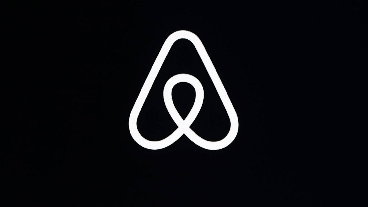 This Feb. 22, 2018, file photo, shows an Airbnb logo during an event in San Francisco. Officials with the short-term-rental company said Tuesday that the temporary party ban it put into effect in 2020 is working, so they decided to make it permanent. (AP Photo/Eric Risberg, File)