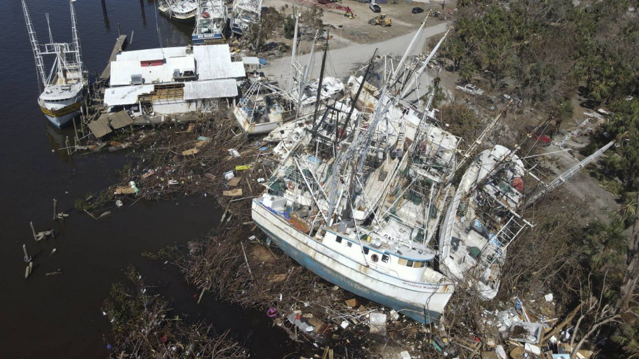 In this photo shot with a drone, grounded shrimp boats lie bunched together amidst debris, following the passage of Hurricane Ian, on San Carlos Island in Fort Myers Beach, Fla., Friday, Oct. 7, 2022. (AP Photo/Rebecca Blackwell)