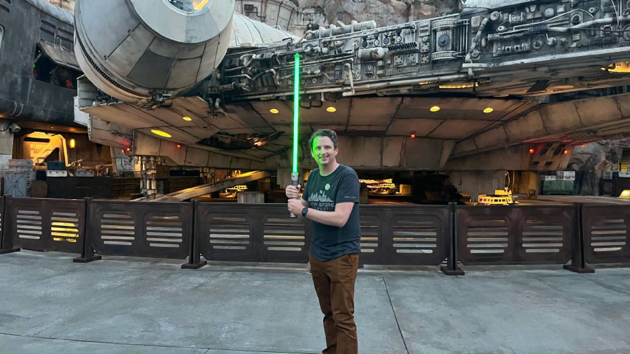 Spectrum Bay News 9's Tim Wronka shows off the lightsaber he created at Disney World's Galaxy's Edge. (Spectrum Bay News 9/Tim Wronka)