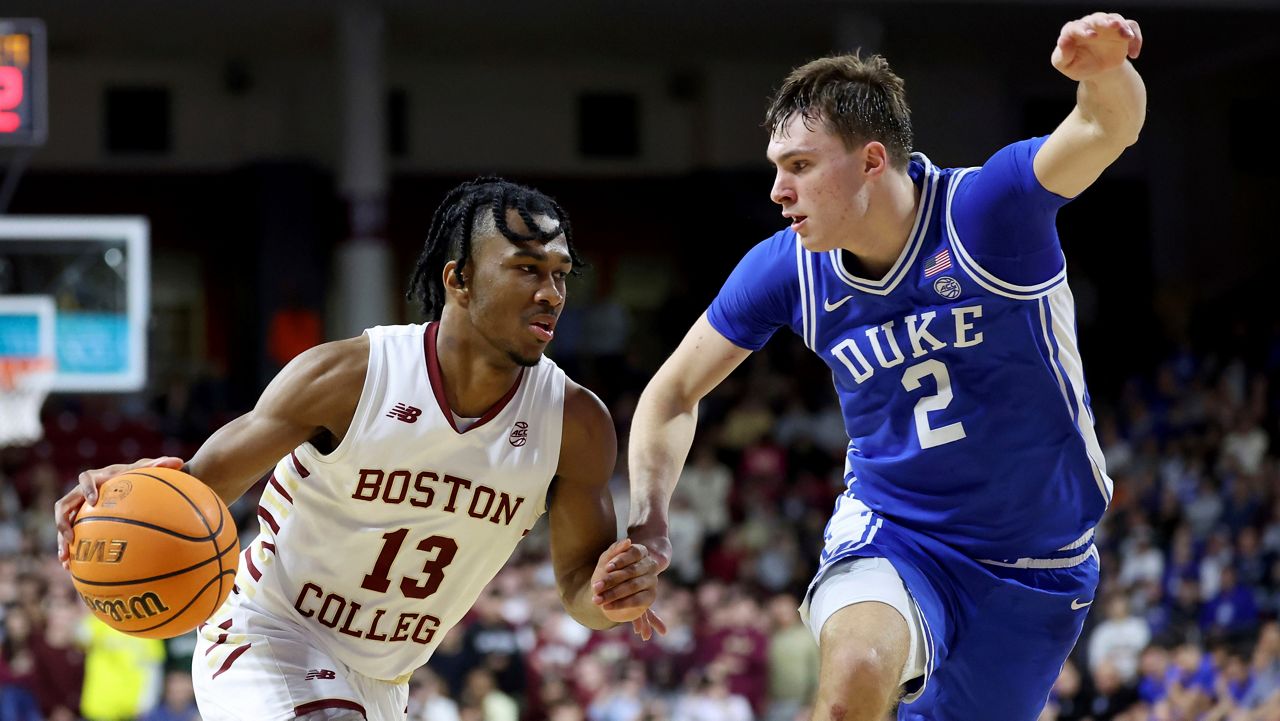 Boston College guard Donald Hand Jr. (13) dribbles around Duke guard Cooper Flagg (2) during the second half of an NCAA college basketball game Saturday, Jan. 18, 2025, in Boston. (AP Photo/Mark Stockwell)