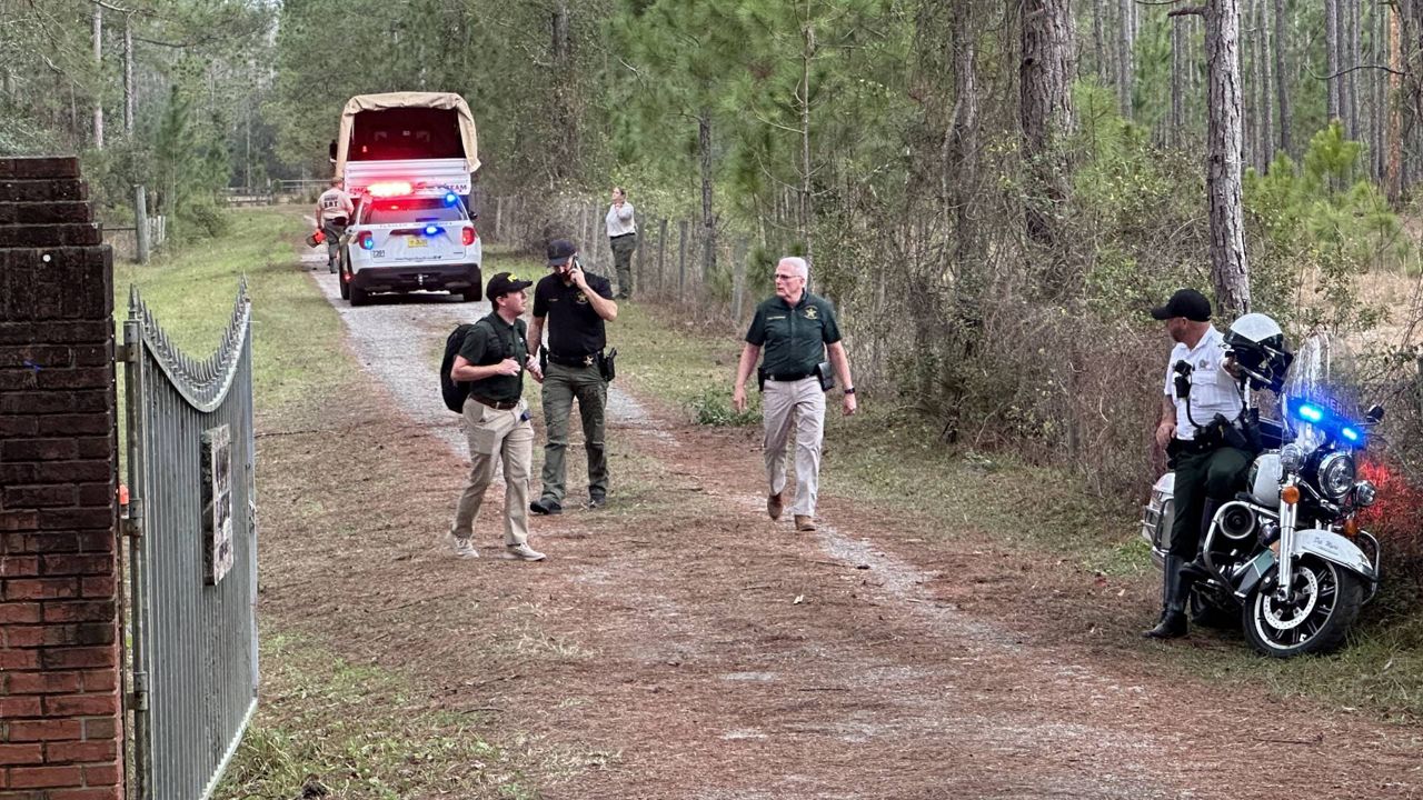 Flagler County Sheriff Rick Staly (center) arrives near the site of where a small plane crashed near the Volusia County line Saturday morning. (Spectrum News/Philip Petersen)