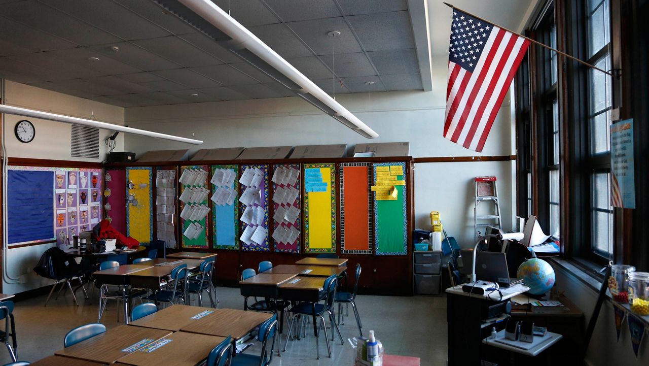 The American flag hangs in a Peck Elementary School classroom Friday, Feb. 1, 2013, in Chicago. 