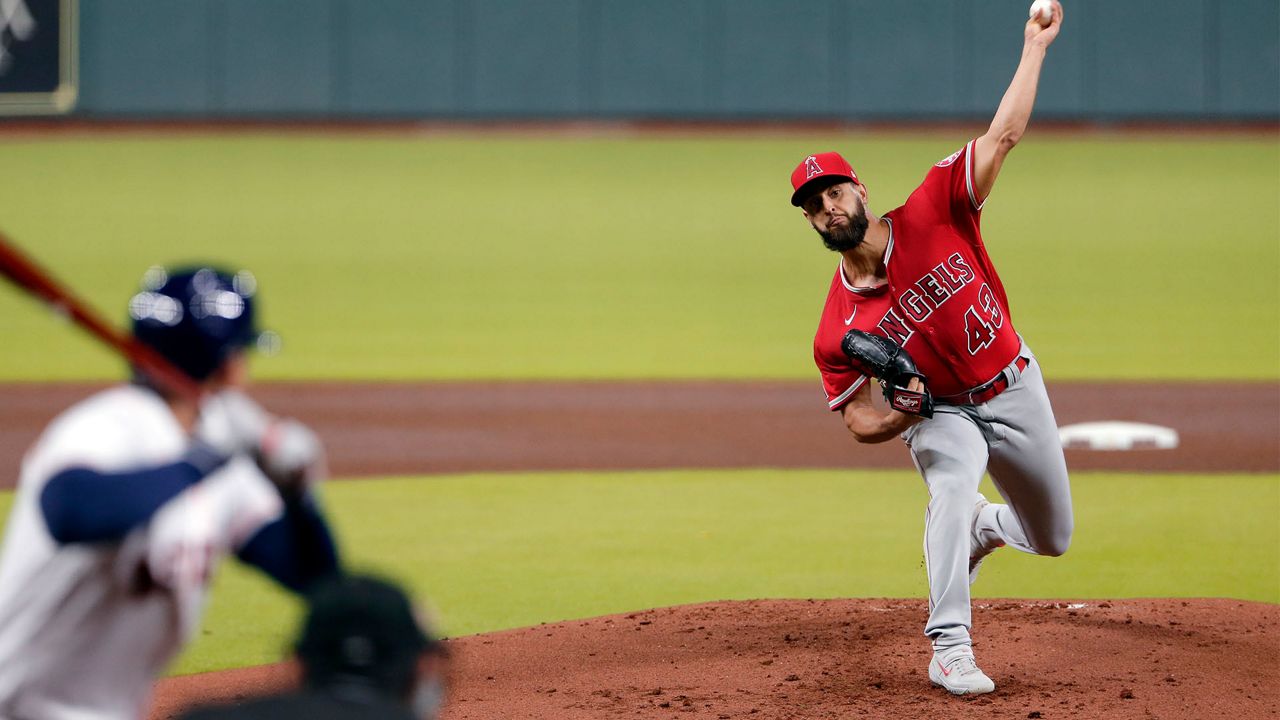 Los Angeles Angels' David Fletcher (22) singles, driving in Andrelton Simmons to score, during the third inning of a baseball game Monday, Aug. 24, 2020, in Houston. (AP Photo/Michael Wyke)