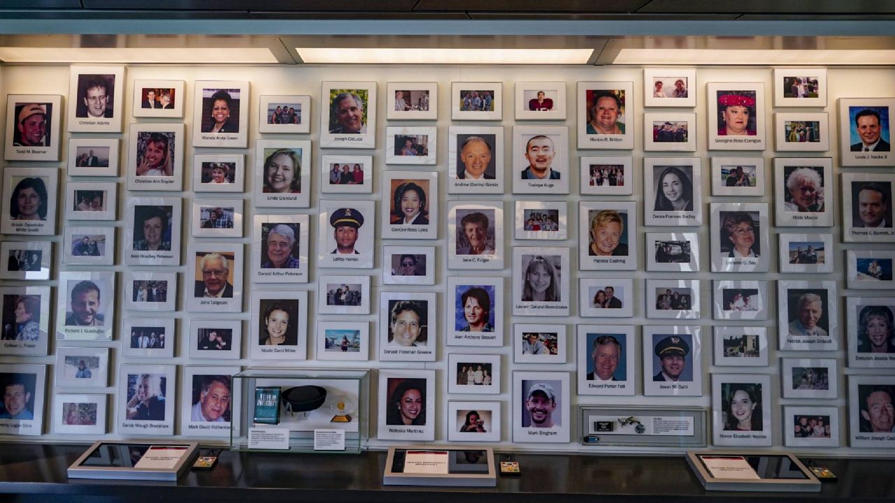 A collection of photographs of the 40 people that died in the crash of Flight 93 in the 9/11 terrorist attacks of 2001 is one the exhibits at the visitors center of the Flight 93 National Memorial, Saturday, May 8, 2021, in Shanksville, Pa. (AP Photo/Keith Srakocic)