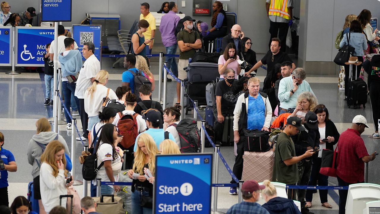Travelers wait in line at the departure area check-in at the United Airlines terminal at Los Angeles International airport, Wednesday June 28, 2023, in Los Angeles. (AP Photo/Damian Dovarganes, File)