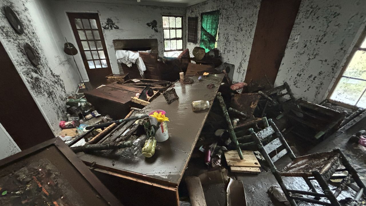 Furniture and personal belongings are covered in mud in Alden Towler's cabin in Hunt, Texas, at 2:37 p.m. on Friday, July 4, 2025, after floodwaters from the Guadalupe River devastated the town. (Alden Towler via AP)