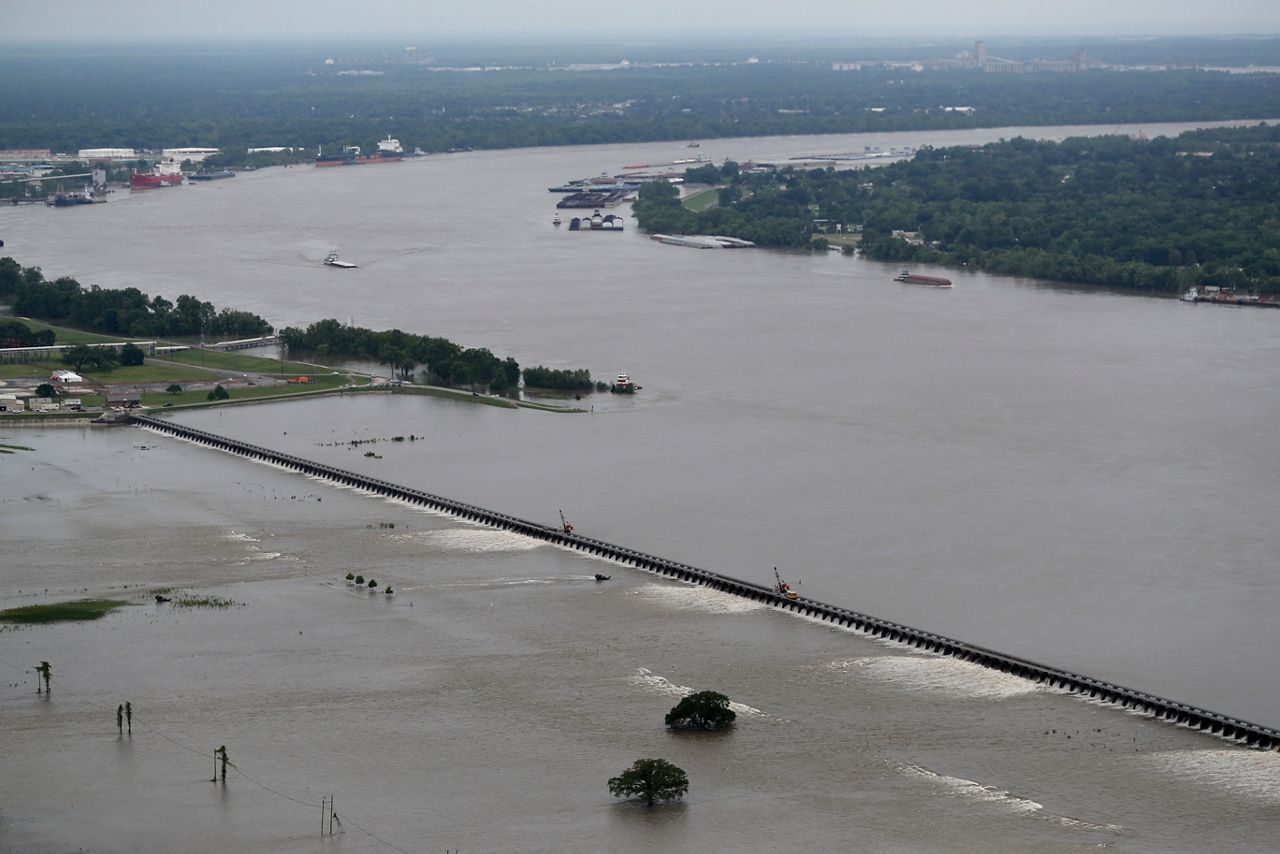 In 2019, workers open bays of the Bonnet Carre Spillway, to divert rising water from the Mississippi River to Lake Pontchartrain, upriver from New Orleans, in Norco, La.