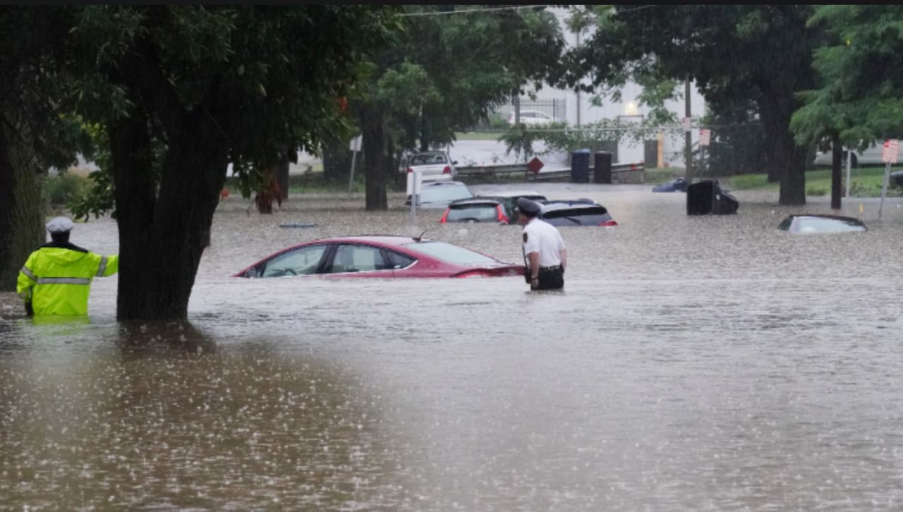 Police wade through flood waters looking for those in their cars, following historic rains causing flooding on streets and houses in St. Louis on Tuesday, July 26, 2022. One fatality was reported after a driver was found in his car in 9 feet of water. Photo by Bill Greenblatt/UPI
