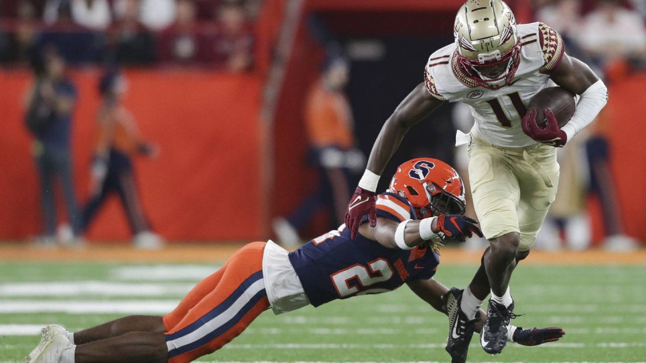 Florida State wide receiver Malik McClain (11) avoids a tackle by Syracuse defensive back Jeremiah Wilson (24) during the first half of an NCAA college football game Saturday, Nov. 12, 2022, in Syracuse, N.Y. (AP Photo/Joshua Bessex)