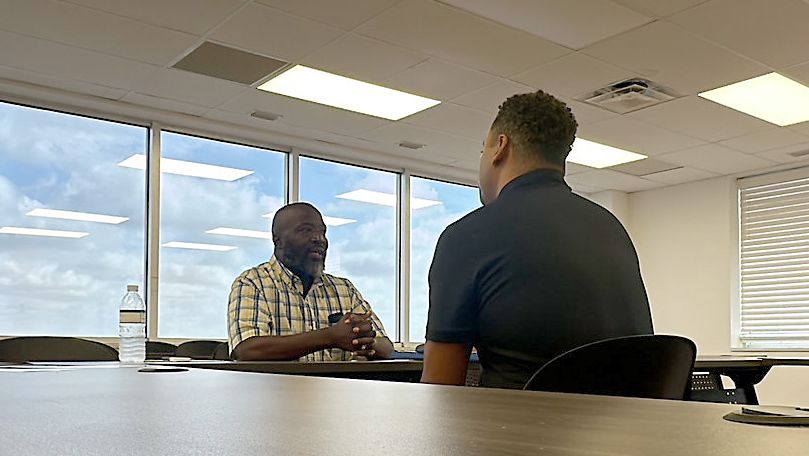 Florida Trade Academy Program Director Mather Ball (right) speaks with Joseph Jackson, who graduated from the academy's reentry program while serving a 12-year prison sentence. (Spectrum Bay News 9/Lizbeth Gutierrez)