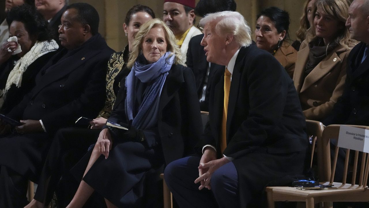 First Lady Jill Biden talks to President-elect Donald Trump sitting in Notre Dame Cathedral as France's iconic cathedral formally reopened its doors for the first time since a devastating fire nearly destroyed the 861-year-old landmark in 2019, Saturday, Dec. 7, 2024 in Paris. (AP Photo/Thibault Camus, Pool)