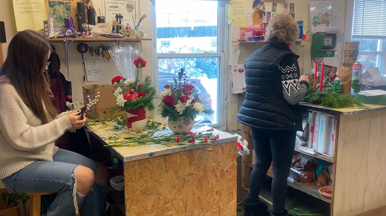 Workers at Viale Florist preparing flower orders for customers.