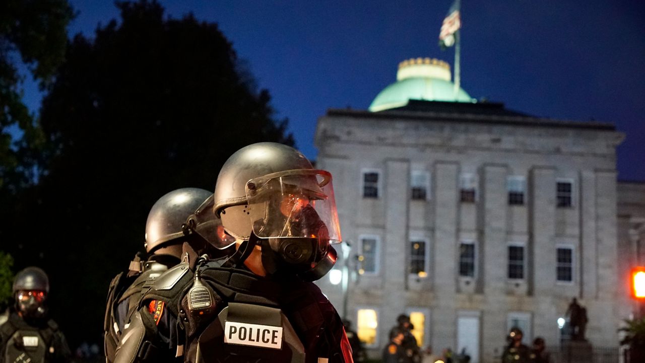 Police in riot gear protect the old state capitol building in downtown Raleigh, N.C., on Sunday, May 31, 2020, on the second day of protests after the death of George Floyd while in Minnesota police custody. (AP file photo/Allen G. Breed)