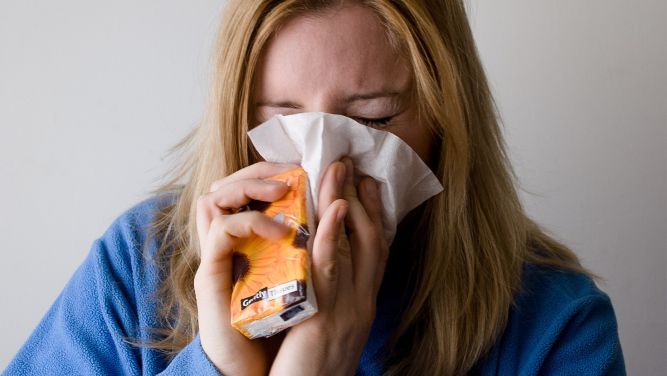 A woman blowing her nose into a tissue. (Spectrum File)