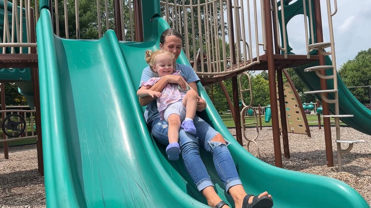 Springfield Mom Heather Bumgarner plays with her daughter at a park in Yellow Springs.