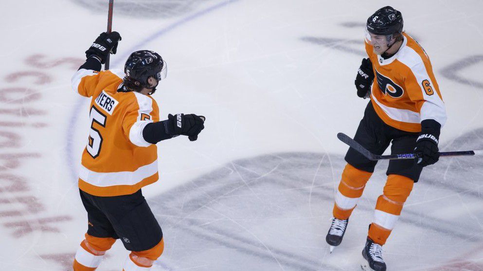 Philadelphia Flyers defenceman Philippe Myers (5) celebrates his game-winning goal in overtime with teammate defenceman Travis Sanheim (6) during overtime in an NHL Stanley Cup Eastern Conference playoff hockey game, Wednesday, Aug. 26, 2020. (Cole Burston/The Canadian Press via AP)