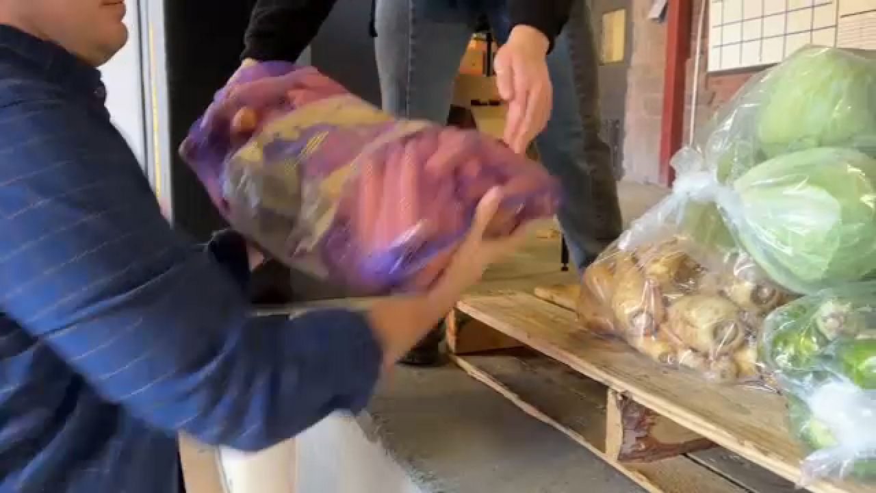 Volunteers stacking food for Thanksgiving donations 