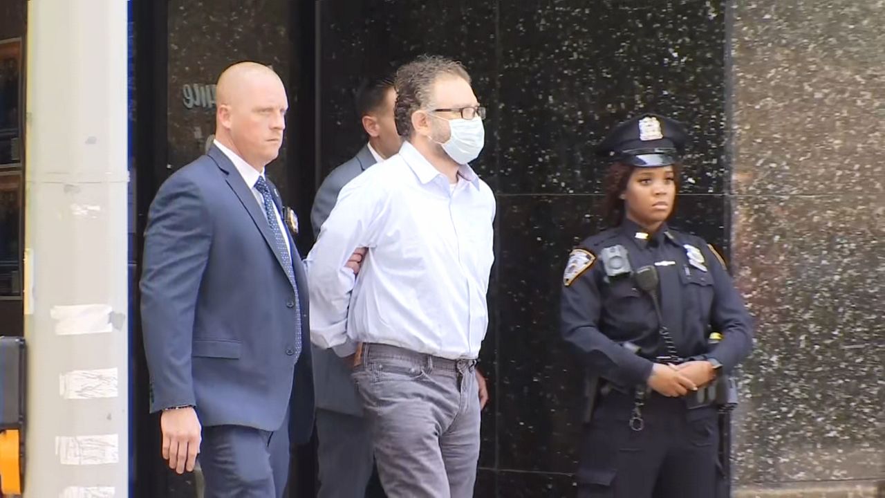 Glenn Hirsch, accused of fatally shooting a Chinese food delivery driver, escorted by police from the 112th Precinct in Forest Hills in June. (NY1 Photo)