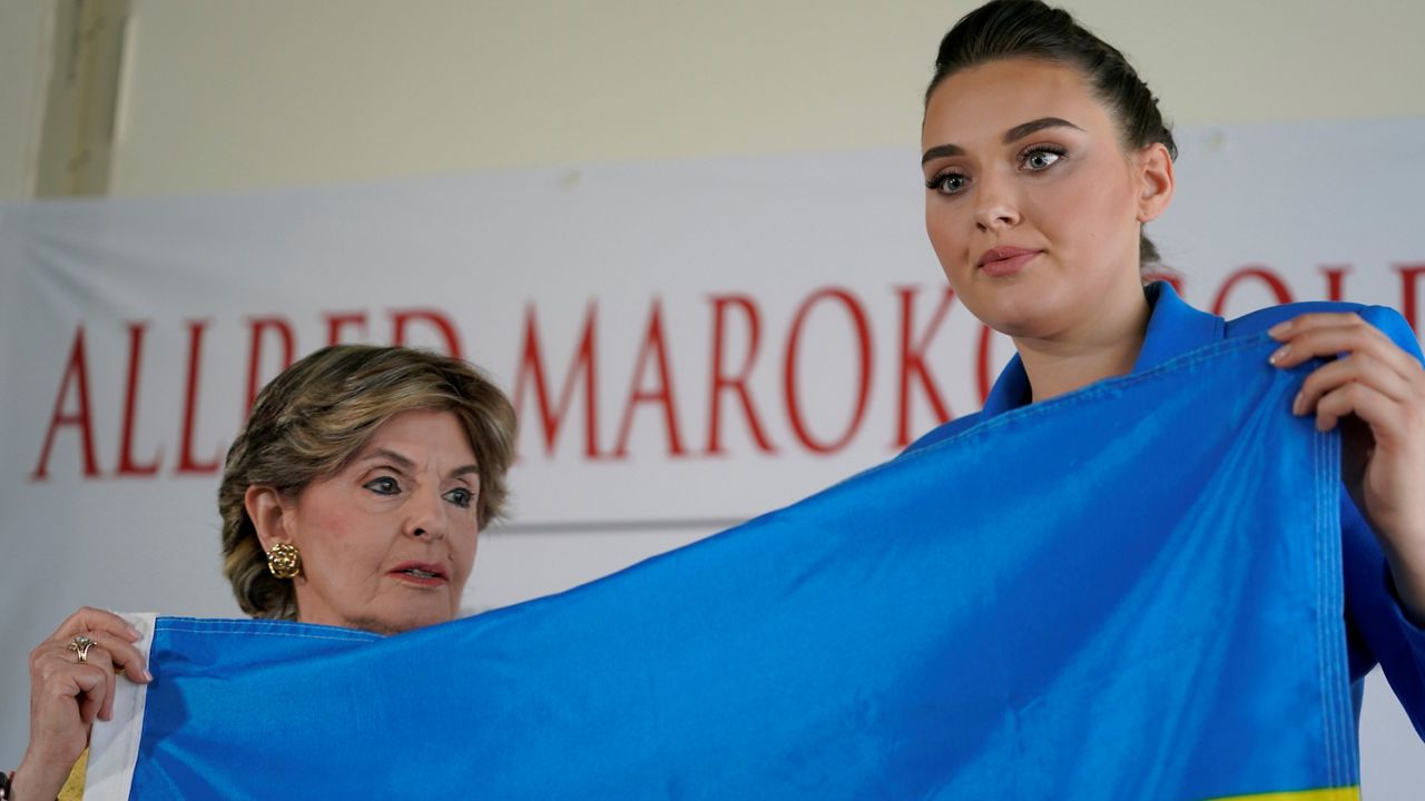 Veronika Didusenko, Miss Ukraine 2018, and women’s rights attorney Gloria Allred, poses for a picture at a news conference at Allred's office in Los Angeles on Tuesday. (AP Photo/Damian Dovarganes)