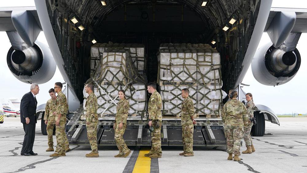 Agriculture Secretary Tom Vilsack, left, greets crew members of a C-17 that delivered a plane load of baby formula at the Indianapolis International Airport in Indianapolis, Sunday, May 22, 2022. The 132 pallets of Nestlé Health Science Alfamino Infant and Alfamino Junior formula arrived from Ramstein Air Base in Germany (AP Photo/Michael Conroy)