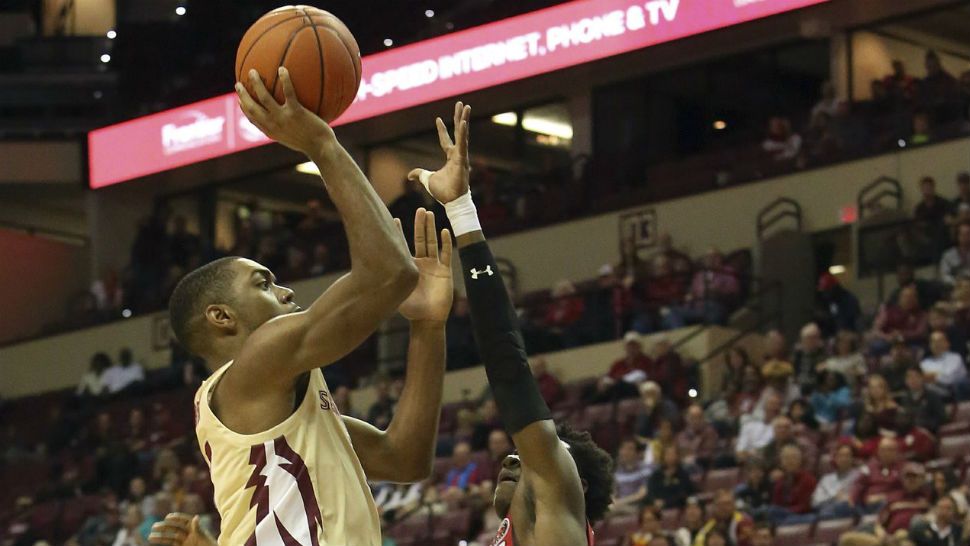 Florida State's Trent Forrest, left shoots over Southeast Missouri's Alex Caldwell in the first half of an NCAA college basketball game Monday, Dec. 17, 2018, in Tallahassee, Fla. (AP Photo/Steve Cannon)