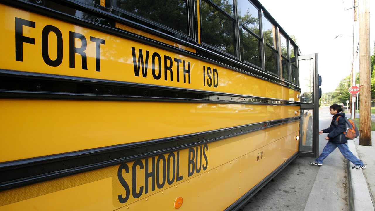 A young student boards a Fort Worth Independent School bus in front of Springdale Elementary School in Fort Worth, Texas, Friday, May 8, 2009. (AP Photo/Tony Gutierrez)