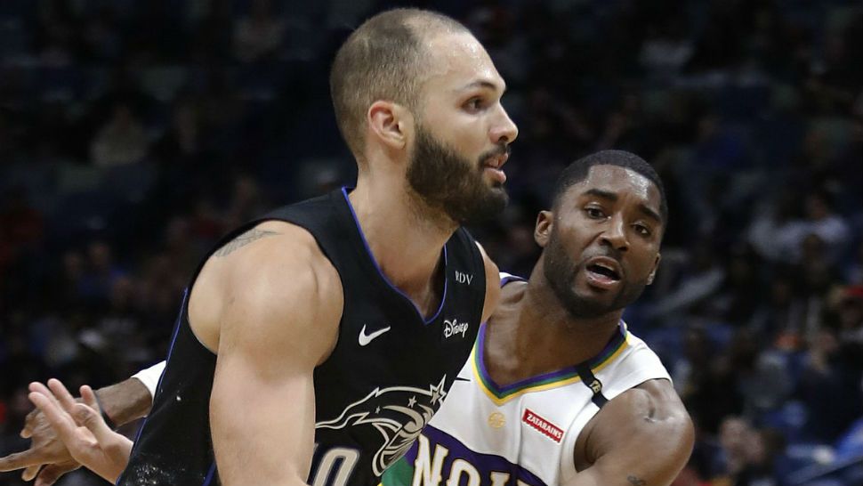 Orlando Magic guard Evan Fournier (10) grabs a rebound between Denver Nuggets forward Trey Lyles (7) and forward Mason Plumlee (24) during the first half of an NBA basketball game Wednesday, Dec. 5, 2018, in Orlando, Fla. (AP Photo/Phelan M. Ebenhack)