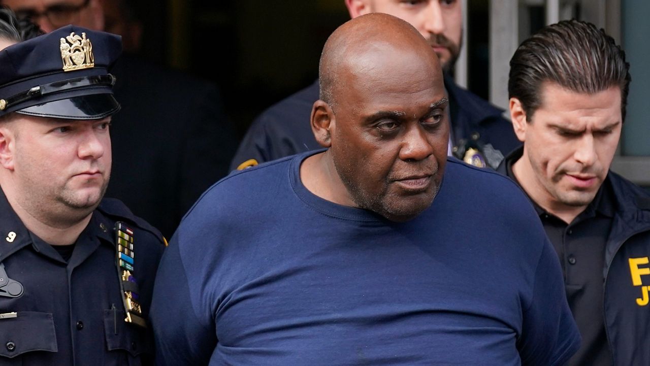 Law enforcement officials lead subway shooting suspect Frank James away from a police station in New York on Wednesday, April 13, 2022.