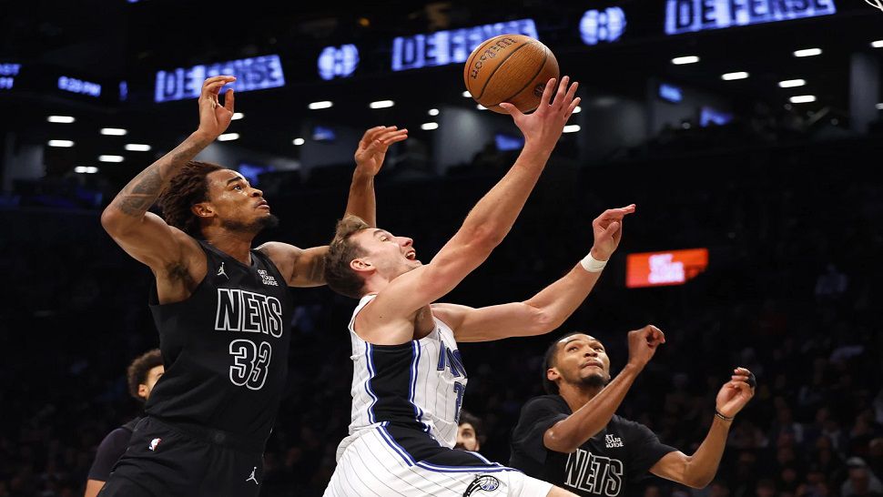 Orlando Magic forward Franz Wagner drives to the basket against Brooklyn Nets center Nic Claxton (33) during the first half of an Emirates NBA Cup basketball game, Friday, Nov. 29, 2024, in New York. (AP Photo/Noah K. Murray)