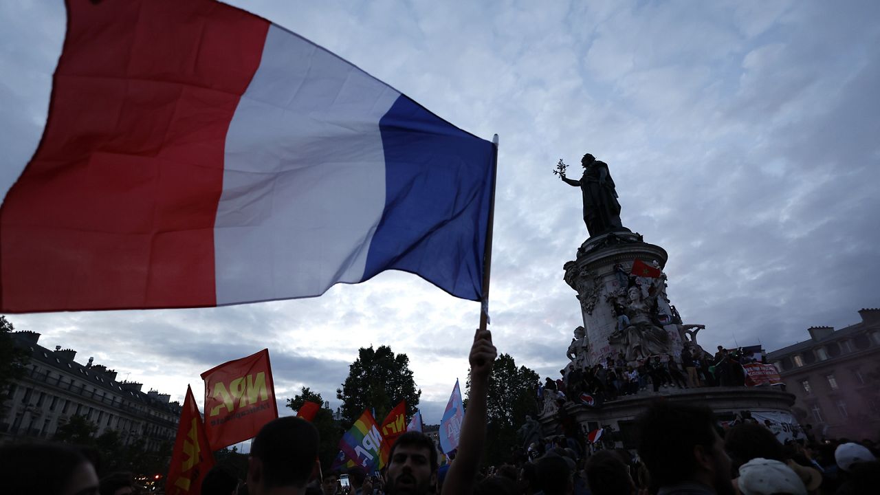 People gather on the Place de la République following the second round of the legislative elections, Sunday, July 7, 2024 in Paris. (AP Photo/Aurelien Morissard)