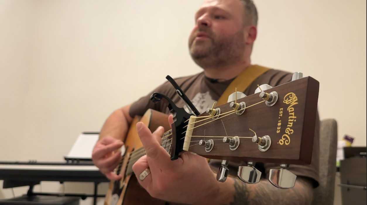 Jesse Frewerd plays his guitar and performs his new song.