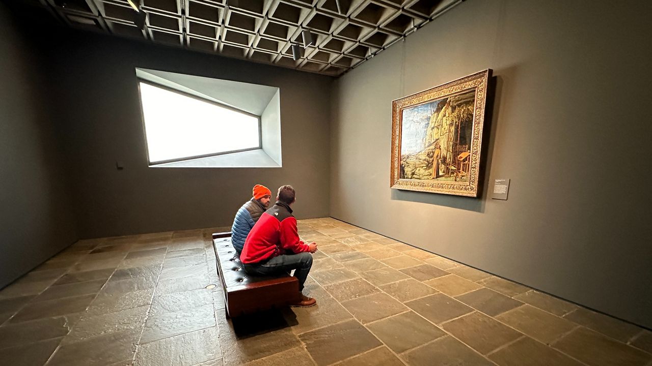 People are pictured looking at art in Manhattan.