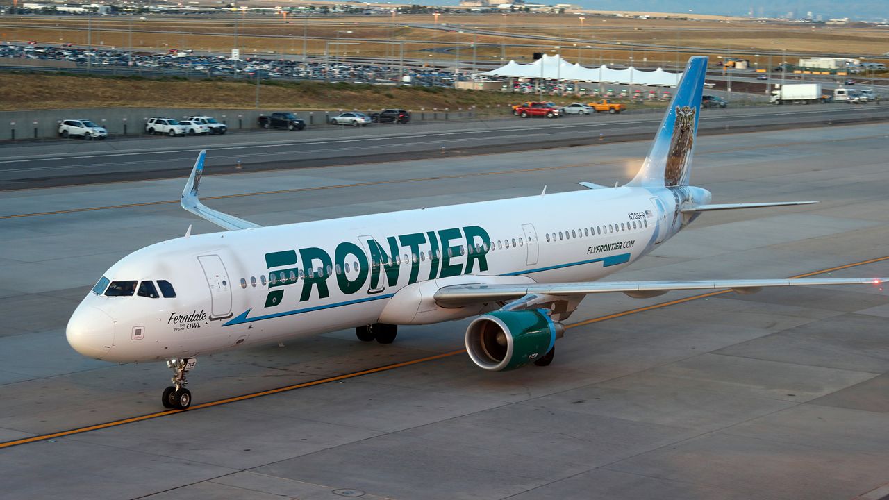 Frontier Airlines airplane sits on a tarmac.