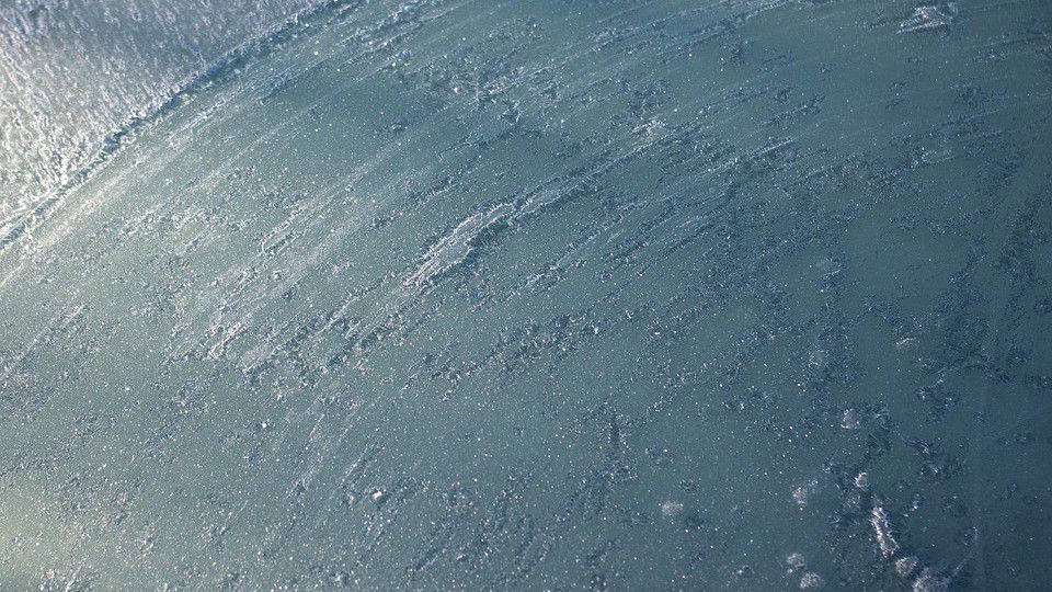 A vehicle windshield is covered with ice in this stock image. (Pixabay)