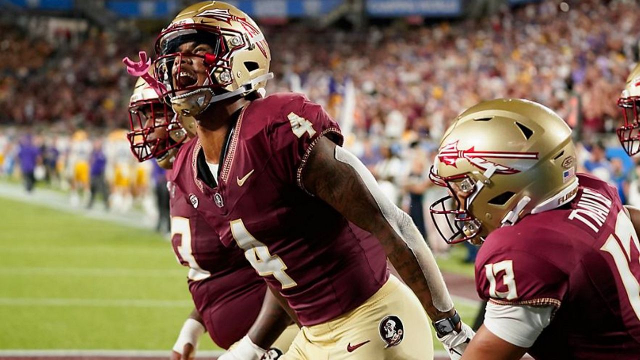 Florida State wide receiver Keon Coleman (4) celebrates after scoring a 7-yard touchdown on a pass play from quarterback Jordan Travis (13) during the second half of an NCAA college football game against LSU, Sunday, Sept. 3, 2023, in Orlando, Fla. (AP Photo/John Raoux)