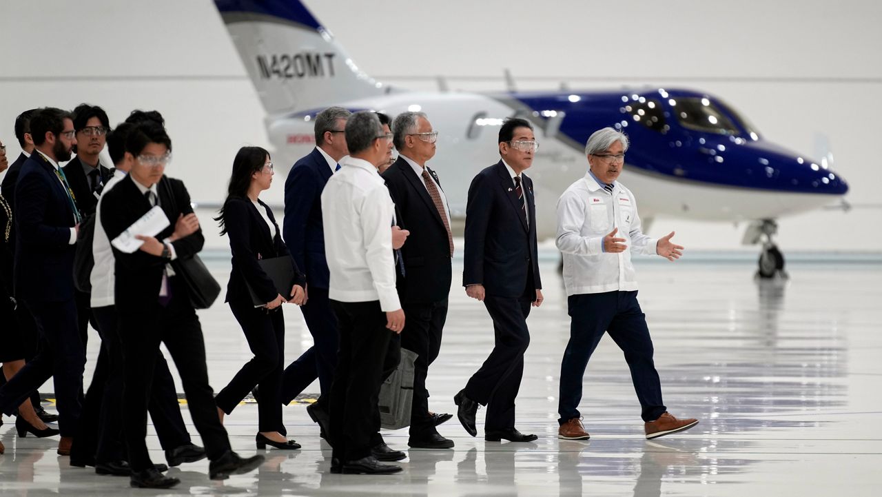 Japanese Prime Minister Fumio Kishida, second from right, walks through the assembly building during a visit to the Honda Aircraft facility in Greensboro, N.C., Friday, April 12, 2024. (AP Photo/Chuck Burton)