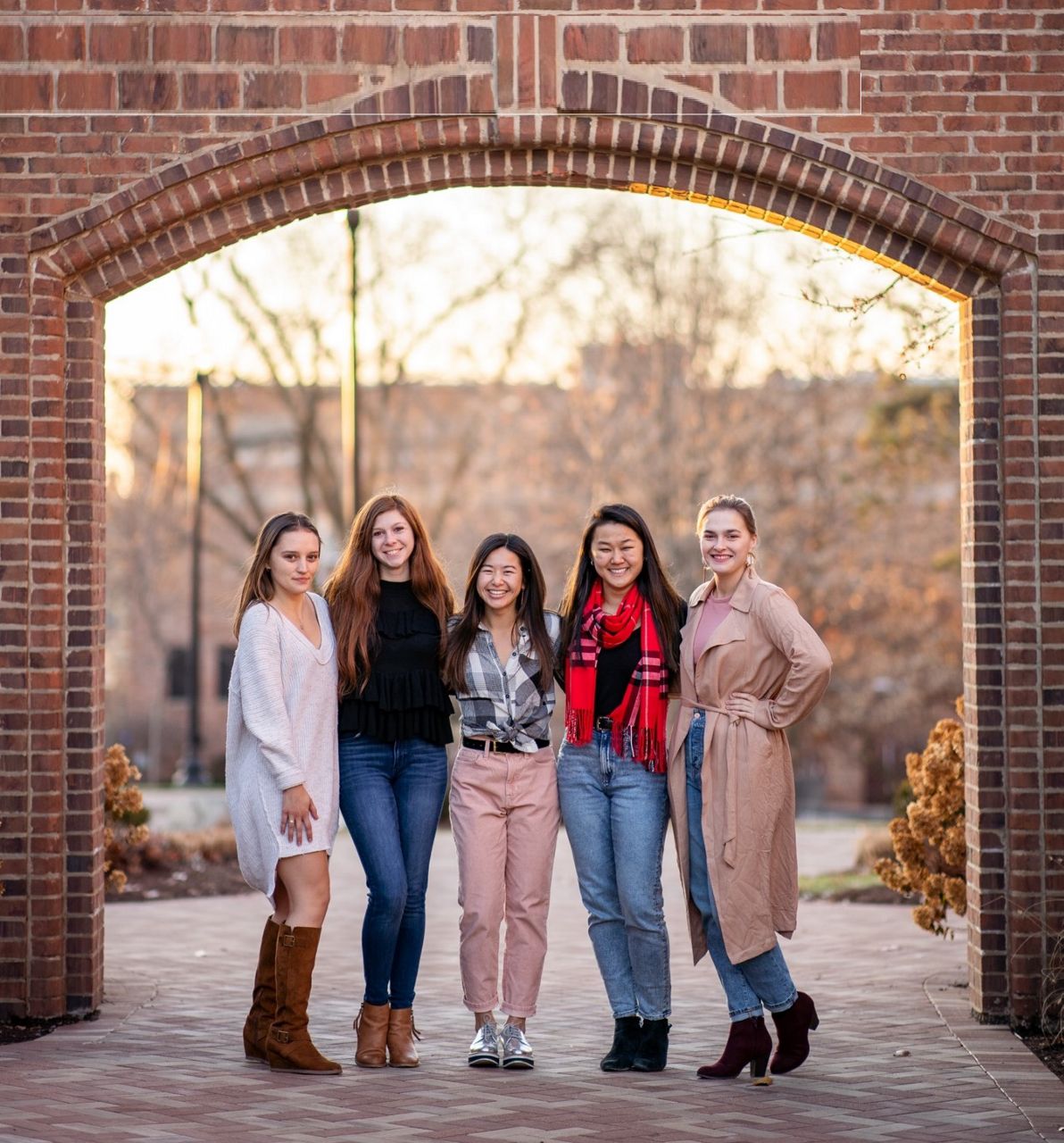 Gabriella Rice (scarf) poses with several of her housemates during her senior year at the University of Dayton. (Photo courtesy of Gabriella Rice)