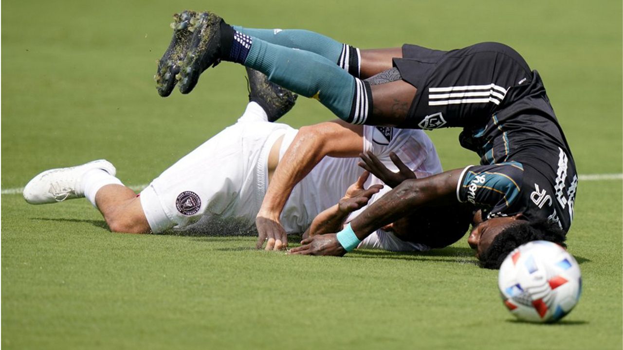 LA Galaxy defender Oniel Fisher, right, and Inter Miami midfielder Rodolfo Pizarro, left, collide during the first half of an MLS soccer match, Sunday, April 18, 2021, in Fort Lauderdale, Fla. (AP Photo/Lynne Sladky)