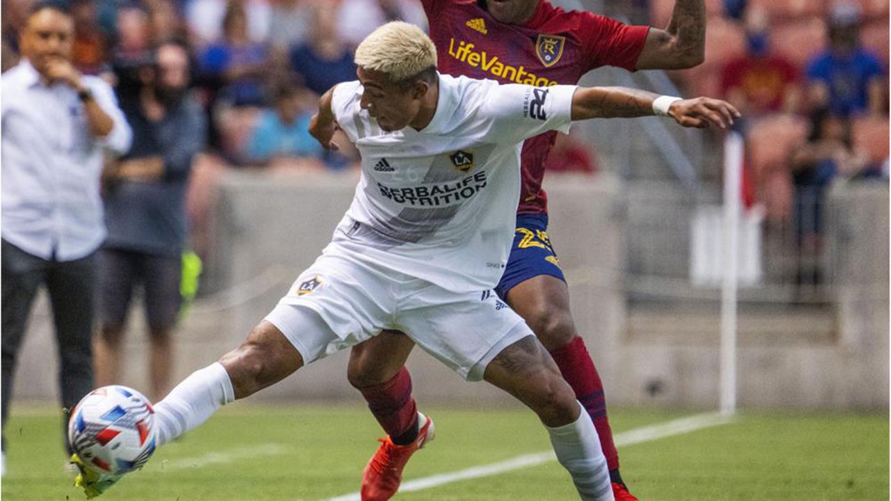 LA Galaxy defender, Julian Araujo, front goes for the ball in front of Real Salt Lake defender Donny Toia (4) during the first half of an MLS soccer match Wednesday, July 21, 2021, in Sandy, Utah. (Rick Egan/The Salt Lake Tribune via AP)