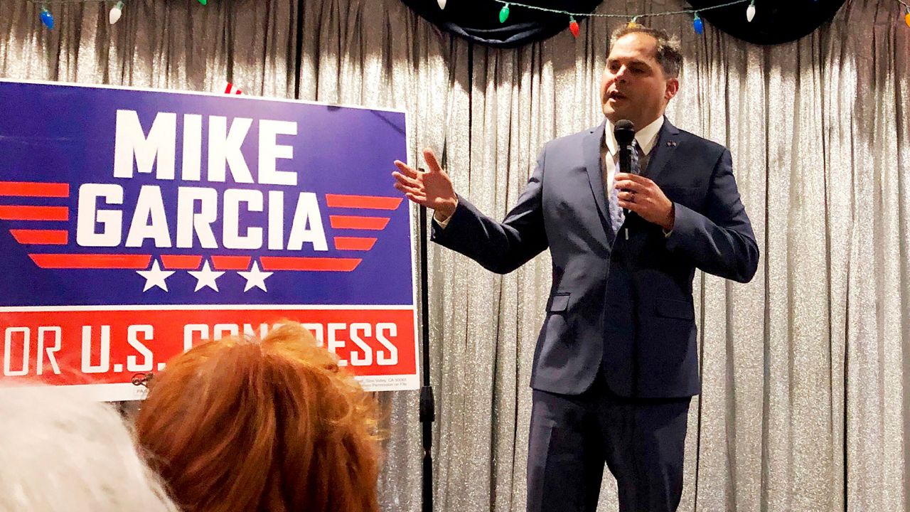 In this Tuesday, Jan. 28, 2020, photo, 25th District congressional candidate and former Navy combat pilot Mike Garcia addresses supporters in Simi Valley, Calif. (AP Photo/Michael Blood)