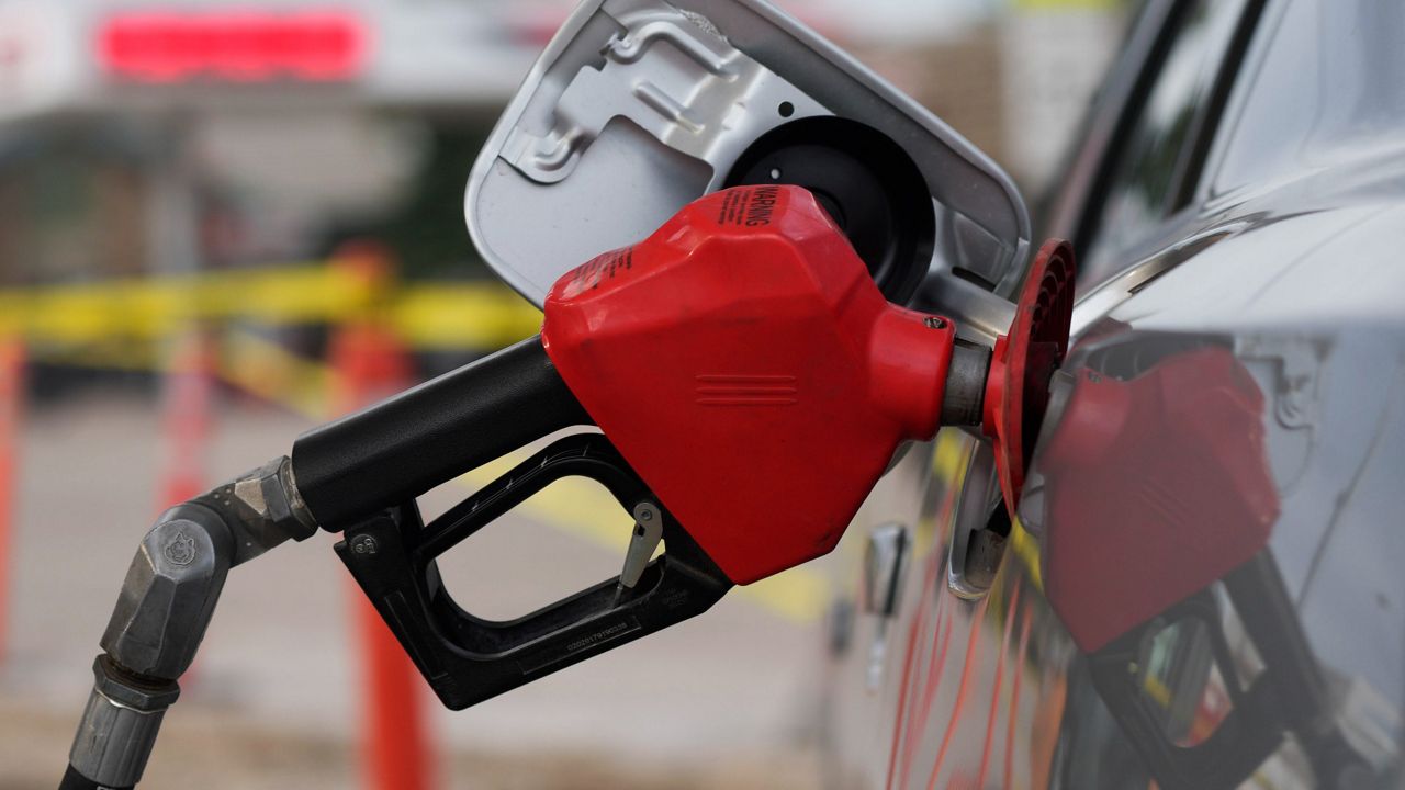 A motorist fills up the tank on a sedan, on July 22, 2022, in Saratoga, Wyo. (AP Photo/David Zalubowski, File)