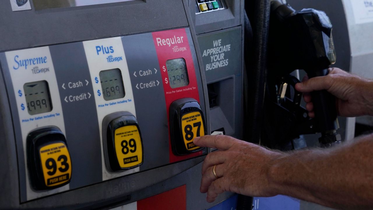 A customer pumps gas at an Exxon gas station in Miami. (AP Photo/Marta Lavandier, File)