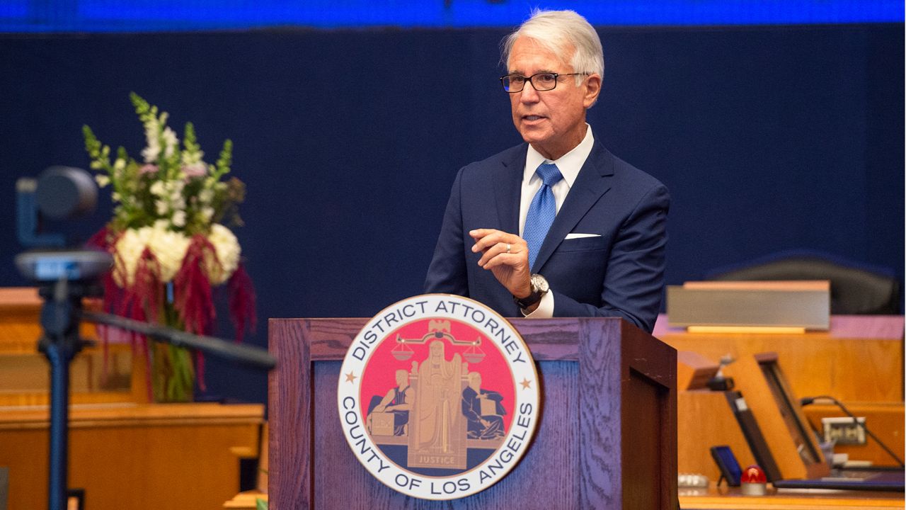 In this photo provided by the County of Los Angeles, incoming Los Angeles County District Attorney George Gascon speaks after he was sworn in during a mostly-virtual ceremony in downtown Los Angeles Monday, Dec. 7, 2020. (Bryan Chan/County of Los Angeles via AP)