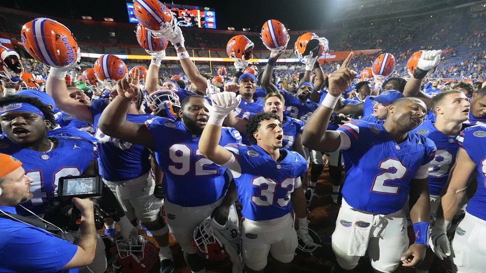 Florida players celebrate after defeating UCF in an NCAA college football game, Saturday, Oct. 5, 2024, in Gainesville, Fla. (AP Photo/John Raoux)