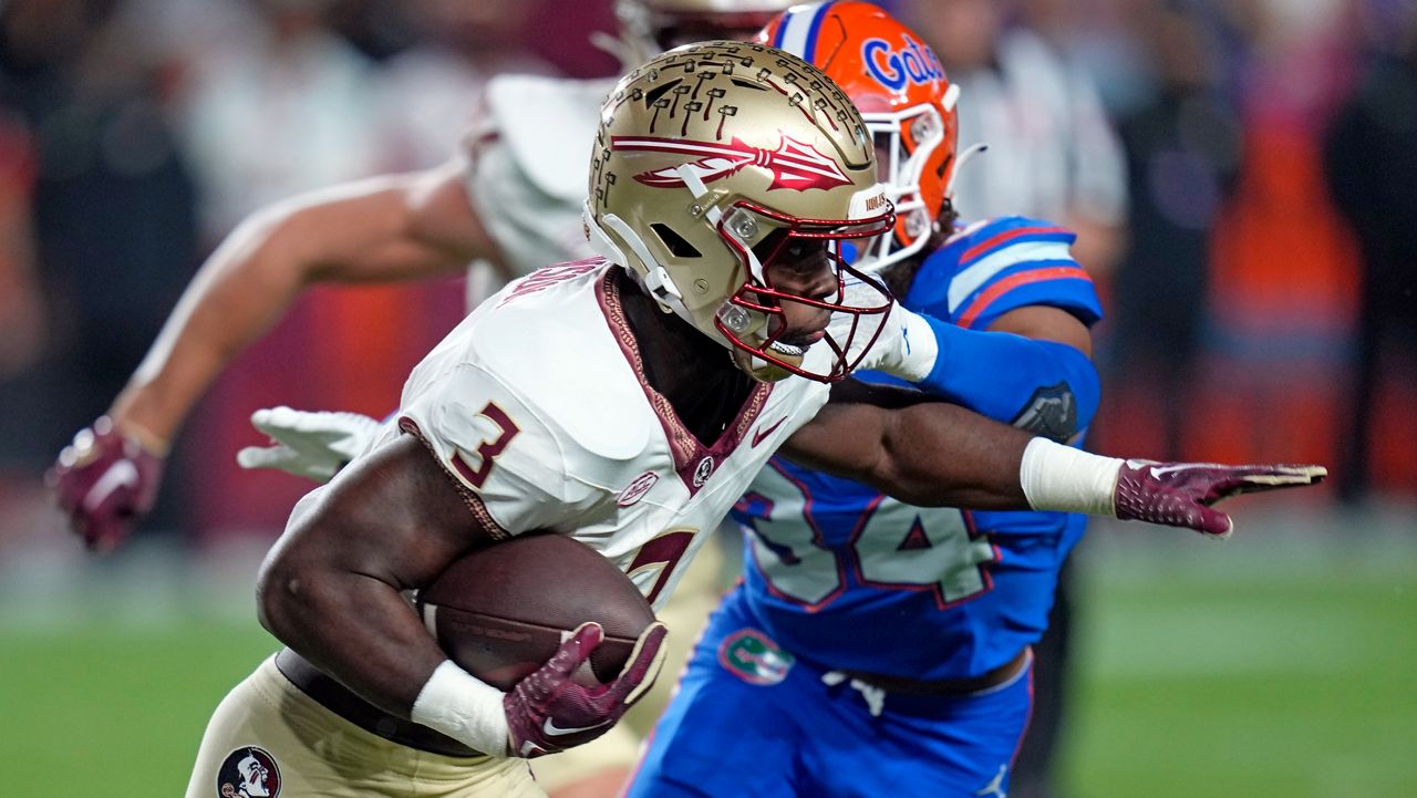Running back Trey Benson (3) is one of several Seminoles who decided to return to the team for an extra season, which has helped spark a 12-0 season so far. (AP Photo/John Raoux)
